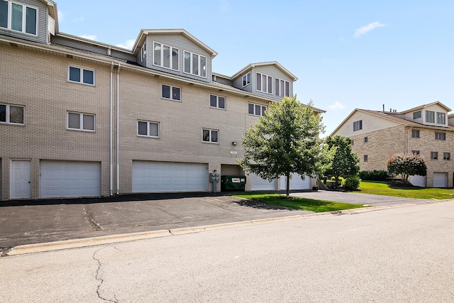 15705 Lake Hills Ct Unit 2N, Orland Park, IL 60462 - view of building exterior featuring an attached garage and driveway