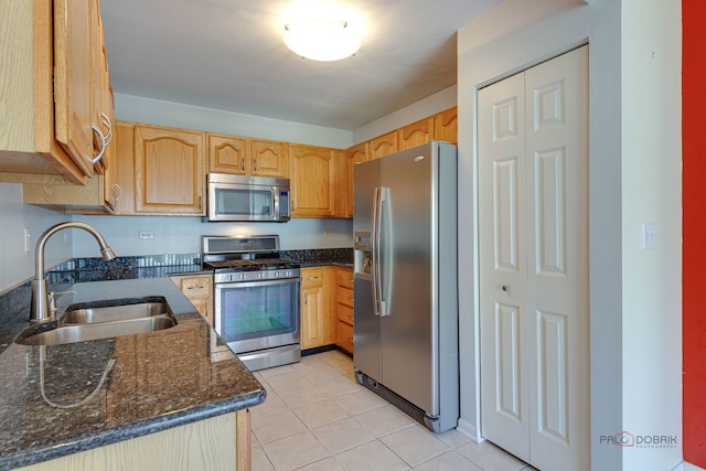 911 Waterford Ln, Elk Grove Village, IL 60007 - kitchen featuring stainless steel appliances, dark stone counters, and light tile patterned flooring