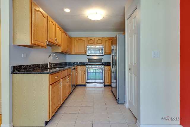 911 Waterford Ln, Elk Grove Village, IL 60007 - kitchen with appliances with stainless steel finishes, dark stone countertops, and light tile patterned floors