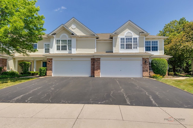 911 Waterford Ln, Elk Grove Village, IL 60007 - multi unit property featuring asphalt driveway, brick siding, and an attached garage