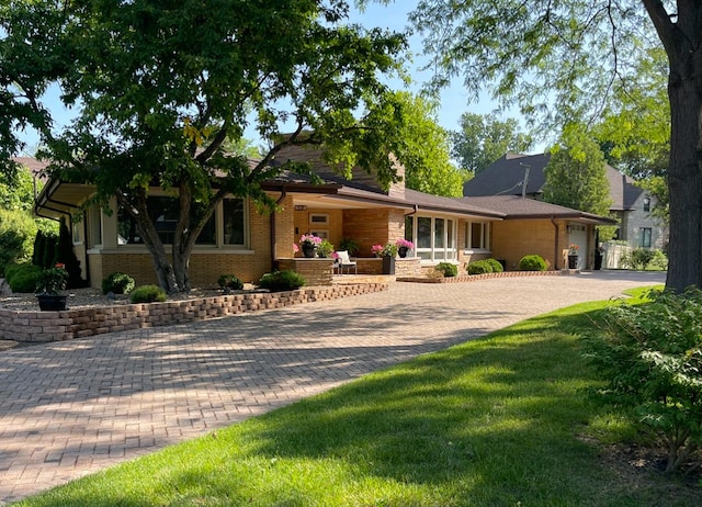 711 E Greenview Rd, Itasca, IL 60143 - view of front of home with decorative driveway, brick siding, a front lawn, and an attached garage