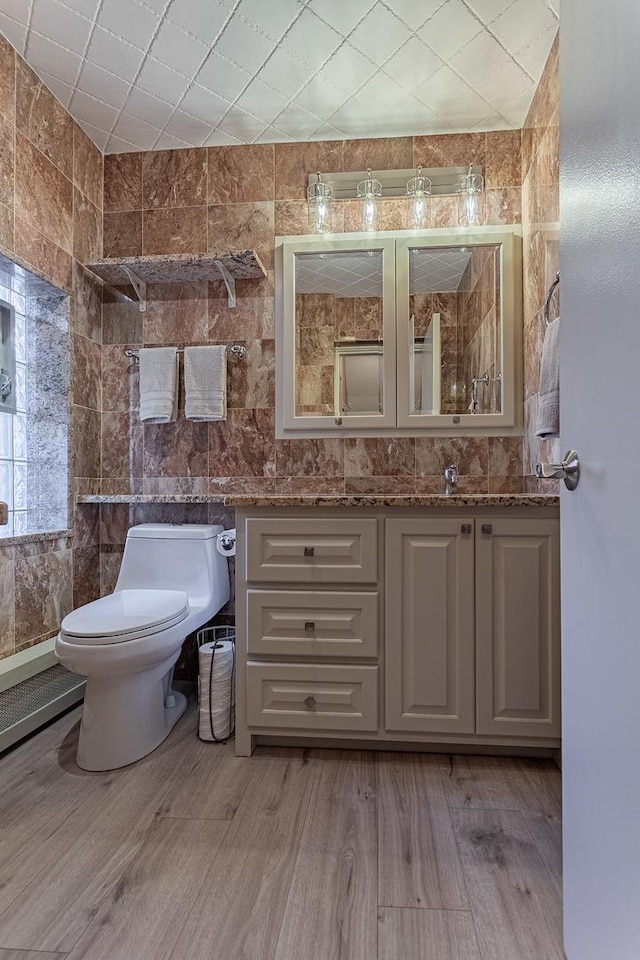 711 E Greenview Rd, Itasca, IL 60143 - bathroom with vanity, wood finished floors, and tile walls