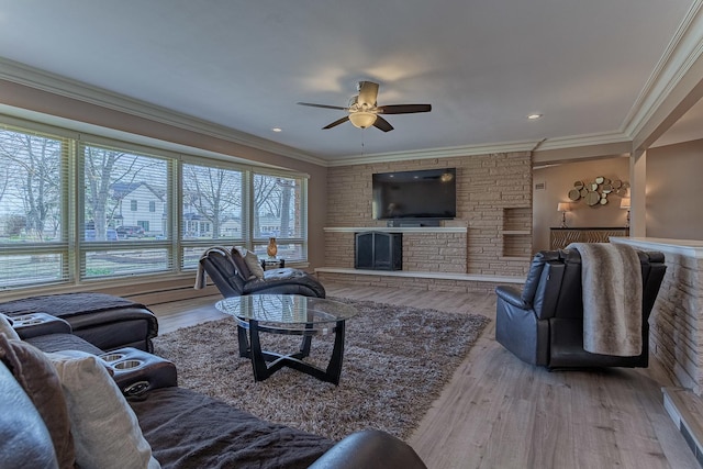 711 E Greenview Rd, Itasca, IL 60143 - living area with ceiling fan, wood finished floors, a fireplace, and ornamental molding