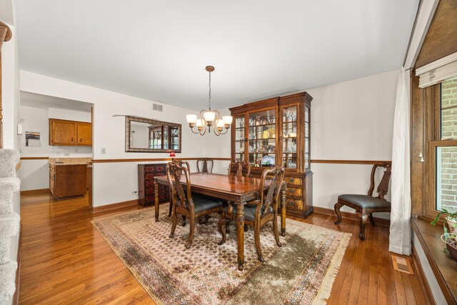 13542 S Erin Dr, Homer Glen, IL 60491 - dining area with light wood-style floors and a chandelier