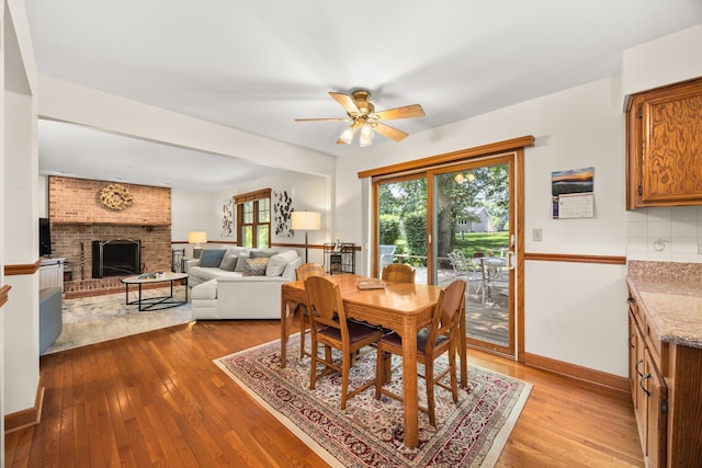 13542 S Erin Dr, Homer Glen, IL 60491 - dining room featuring hardwood / wood-style flooring, ceiling fan, and a fireplace