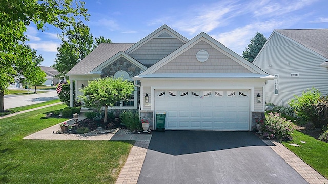 11642 Sunderlin Dr, Huntley, IL 60142 - view of front facade with stone siding, asphalt driveway, a front lawn, and a garage