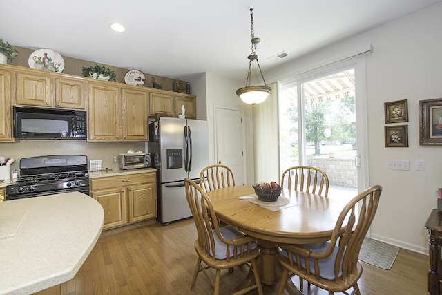 11642 Sunderlin Dr, Huntley, IL 60142 - kitchen featuring black appliances, light countertops, light wood finished floors, hanging light fixtures, and recessed lighting