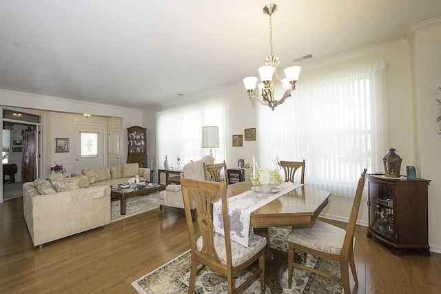 11642 Sunderlin Dr, Huntley, IL 60142 - dining area with a chandelier, crown molding, and wood finished floors
