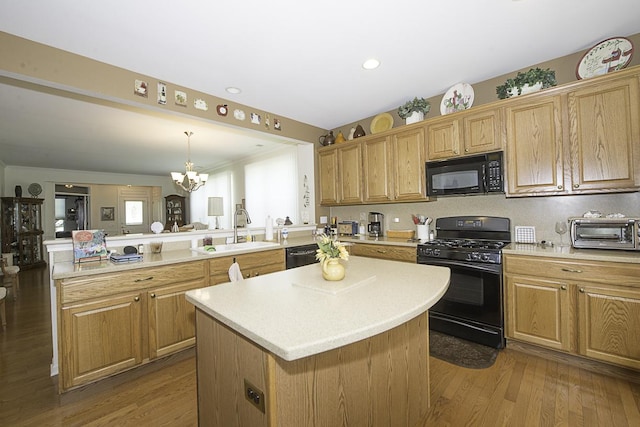 11642 Sunderlin Dr, Huntley, IL 60142 - kitchen featuring black appliances, a peninsula, a center island, light countertops, and a chandelier