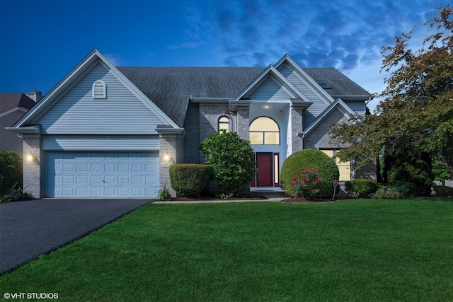 3175 Wild Meadow Ln, Aurora, IL 60504 - traditional-style home with asphalt driveway, brick siding, an attached garage, and a front lawn