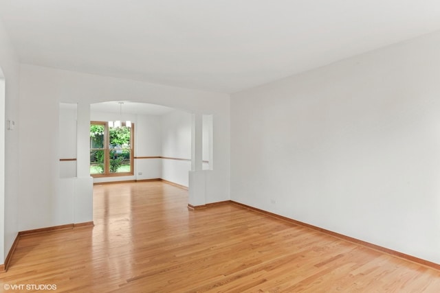3175 Wild Meadow Ln, Aurora, IL 60504 - unfurnished room with light wood-style flooring and arched walkways