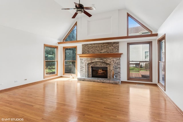3175 Wild Meadow Ln, Aurora, IL 60504 - unfurnished living room featuring high vaulted ceiling, wood finished floors, a brick fireplace, and a ceiling fan