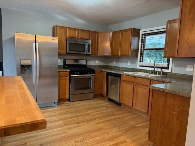1038 Ruth Crane Dr, Rantoul, IL 61866 - kitchen with stainless steel appliances, light wood-type flooring, and brown cabinetry