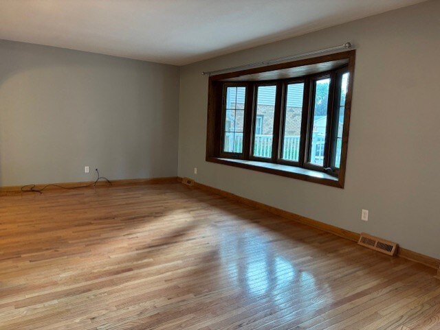 1038 Ruth Crane Dr, Rantoul, IL 61866 - empty room with wood finished floors and baseboards