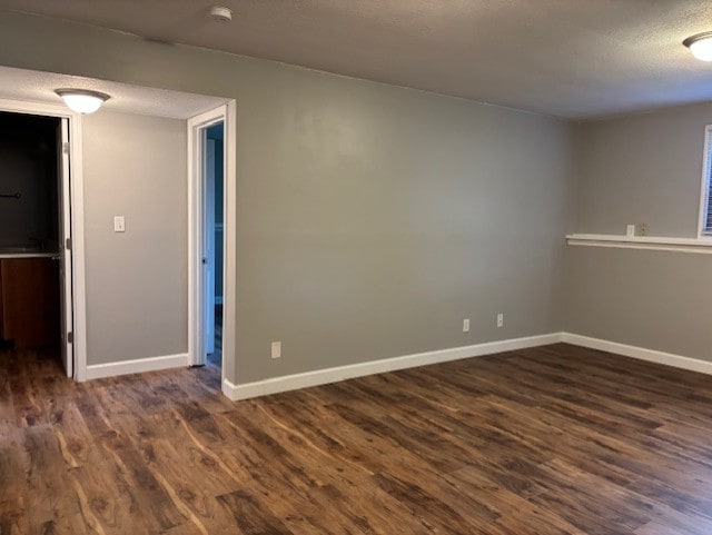 1038 Ruth Crane Dr, Rantoul, IL 61866 - spare room featuring dark wood-type flooring, a smoke detector, and a textured ceiling