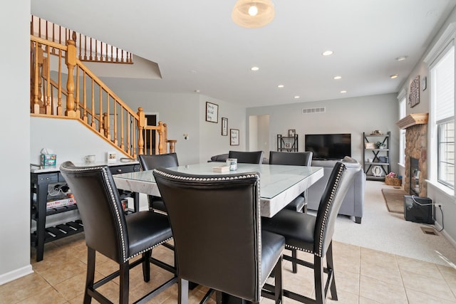 17857 Wilker Dr, Lockport, IL 60441 - dining room featuring light tile patterned flooring, stairway, recessed lighting, light carpet, and a fireplace