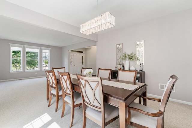 17857 Wilker Dr, Lockport, IL 60441 - dining area featuring light colored carpet and a chandelier