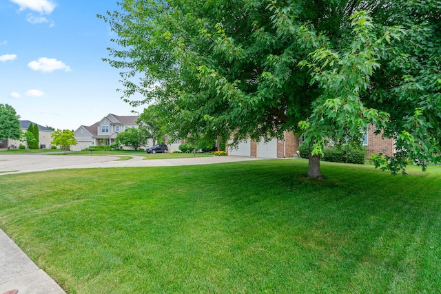 17857 Wilker Dr, Lockport, IL 60441 - view of front of house featuring concrete driveway, a front yard, a residential view, a garage, and brick siding