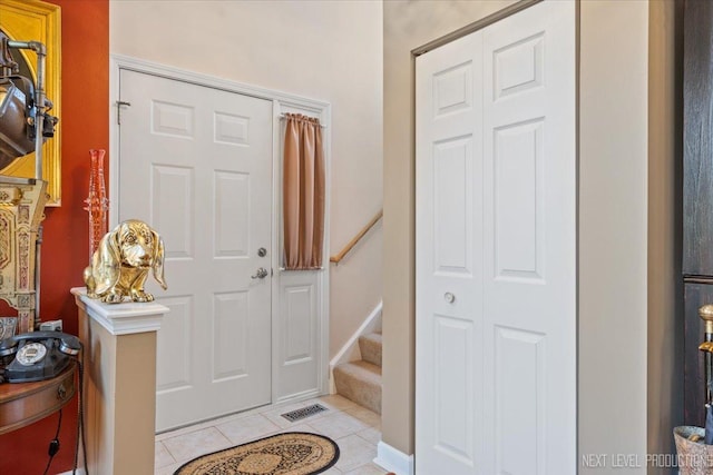 251 Abington Ln, North Aurora, IL 60542 - entryway with light tile patterned floors and stairway