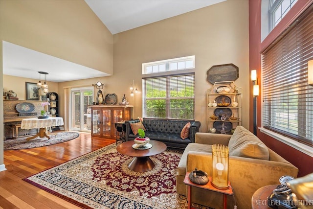 251 Abington Ln, North Aurora, IL 60542 - living area with high vaulted ceiling, wood finished floors, and a chandelier