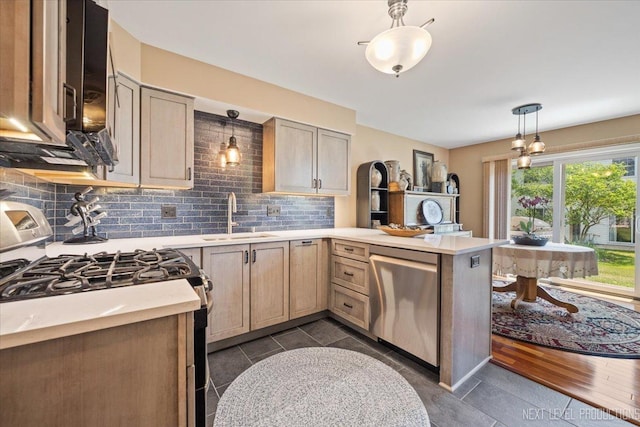 251 Abington Ln, North Aurora, IL 60542 - kitchen with stainless steel appliances, a peninsula, light countertops, decorative backsplash, and hanging light fixtures