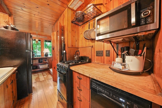 3720 E Lake Shore Dr, Wonder Lake, IL 60097 - kitchen with black appliances, butcher block counters, hardwood / wood-style flooring, wood walls, and wood ceiling