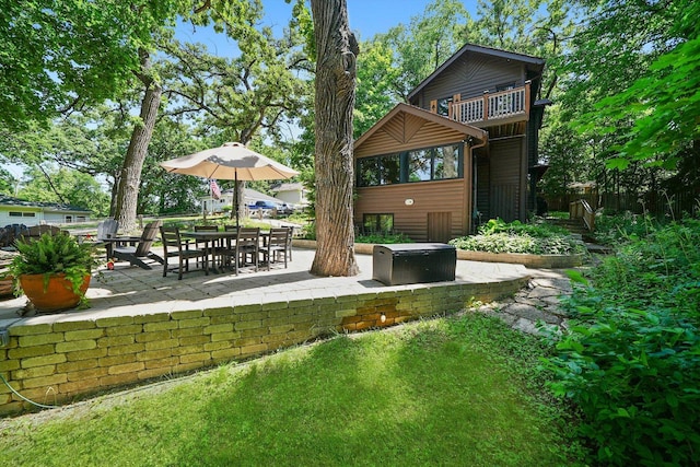 3720 E Lake Shore Dr, Wonder Lake, IL 60097 - rear view of house with a patio and a balcony
