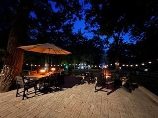 3720 E Lake Shore Dr, Wonder Lake, IL 60097 - patio at twilight featuring an outdoor fire pit and a wooden deck
