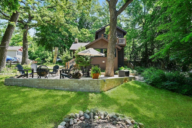 3720 E Lake Shore Dr, Wonder Lake, IL 60097 - view of yard featuring a fire pit, a patio area, and a balcony