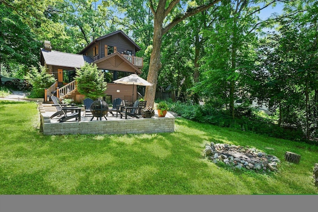 3720 E Lake Shore Dr, Wonder Lake, IL 60097 - view of grassy yard with a fire pit, a patio, a balcony, and stairway