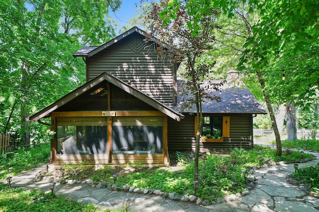 3720 E Lake Shore Dr, Wonder Lake, IL 60097 - view of front of home featuring faux log siding and a sunroom