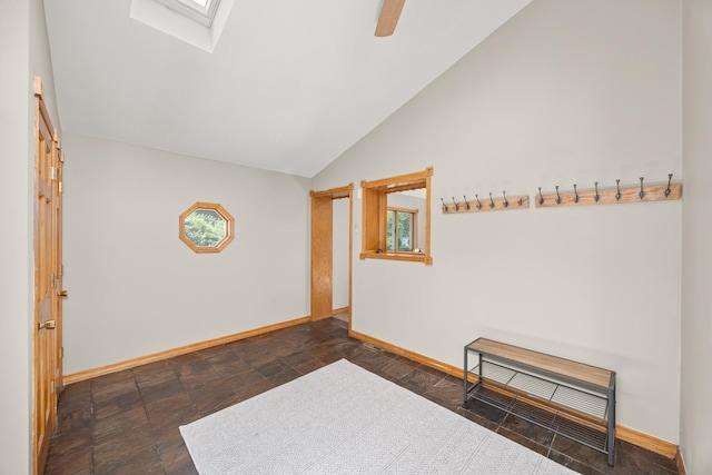 1649 Larry Ln, Glendale Heights, IL 60139 - spare room featuring lofted ceiling, a skylight, stone finish flooring, and ceiling fan