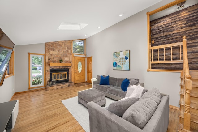 1649 Larry Ln, Glendale Heights, IL 60139 - living room featuring a skylight, light wood finished floors, a fireplace, vaulted ceiling, and recessed lighting