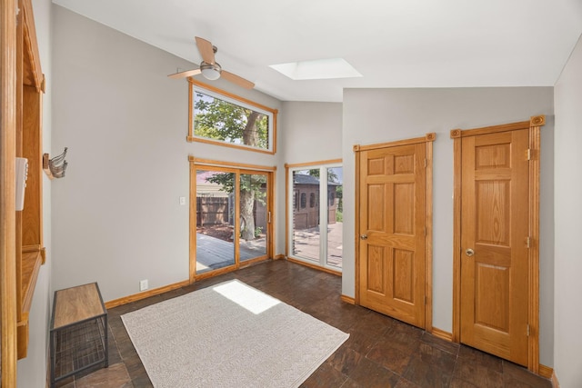 1649 Larry Ln, Glendale Heights, IL 60139 - foyer with a skylight, ceiling fan, dark stone finish floors, and high vaulted ceiling
