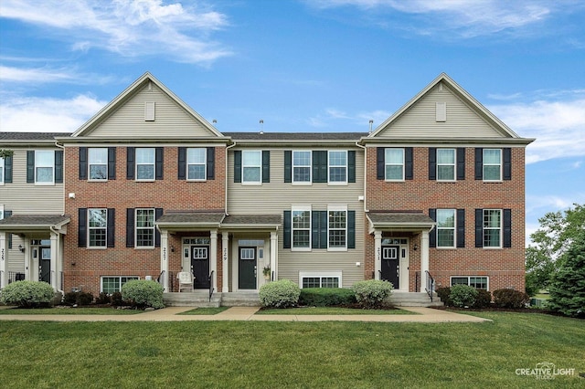 229 Lakeshore Dr, Oswego, IL 60543 - view of front facade with a front yard and brick siding