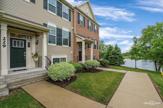229 Lakeshore Dr, Oswego, IL 60543 - doorway to property featuring a water view and a lawn