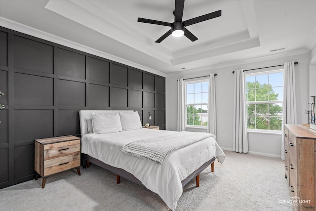 229 Lakeshore Dr, Oswego, IL 60543 - bedroom featuring a tray ceiling, ornamental molding, light colored carpet, a decorative wall, and ceiling fan