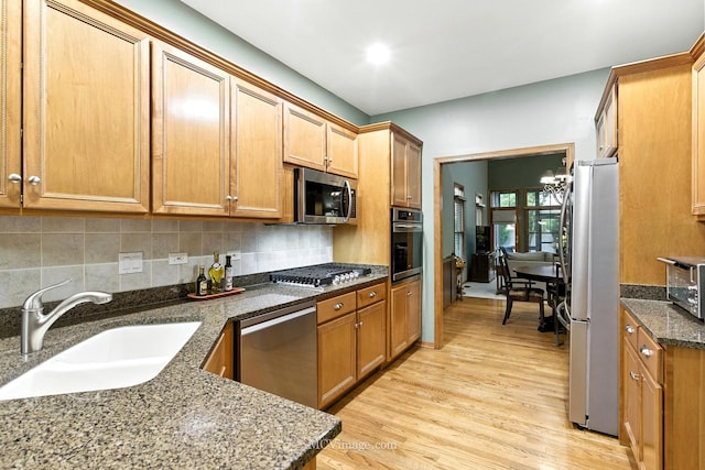 21730 Higley Ln, Frankfort, IL 60423 - kitchen with stainless steel appliances, light wood finished floors, dark stone countertops, backsplash, and brown cabinetry