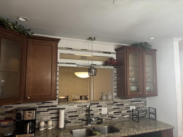 744 Academy Ave, Matteson, IL 60443 - kitchen with decorative backsplash, glass insert cabinets, stone counters, hanging light fixtures, and dark brown cabinetry
