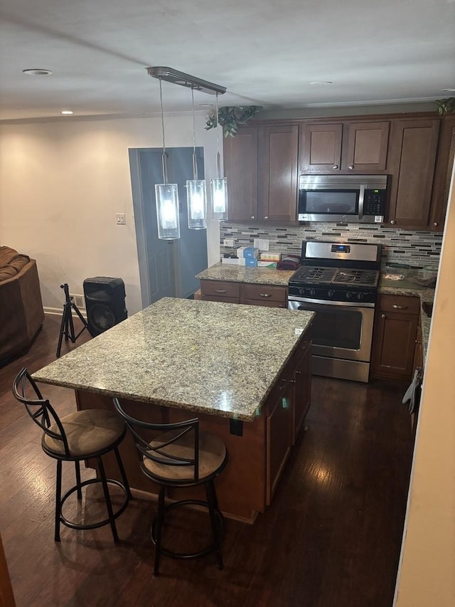 744 Academy Ave, Matteson, IL 60443 - kitchen with stainless steel appliances, a center island, dark wood-type flooring, and decorative backsplash