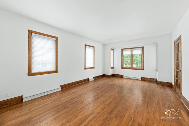 330 S Maple St, Itasca, IL 60143 - unfurnished bedroom featuring a baseboard heating unit and wood finished floors