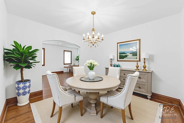 330 S Maple St, Itasca, IL 60143 - dining space with a chandelier, wood finished floors, and arched walkways