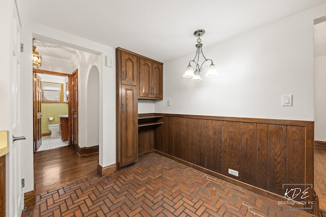 330 S Maple St, Itasca, IL 60143 - kitchen featuring arched walkways, a wainscoted wall, and pendant lighting