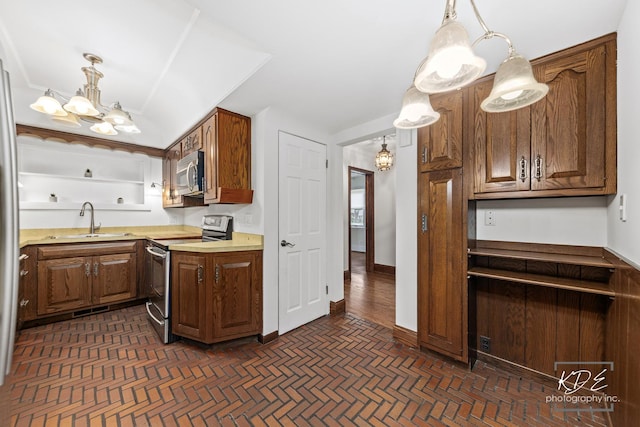 330 S Maple St, Itasca, IL 60143 - kitchen with appliances with stainless steel finishes, light countertops, a chandelier, hanging light fixtures, and brown cabinetry