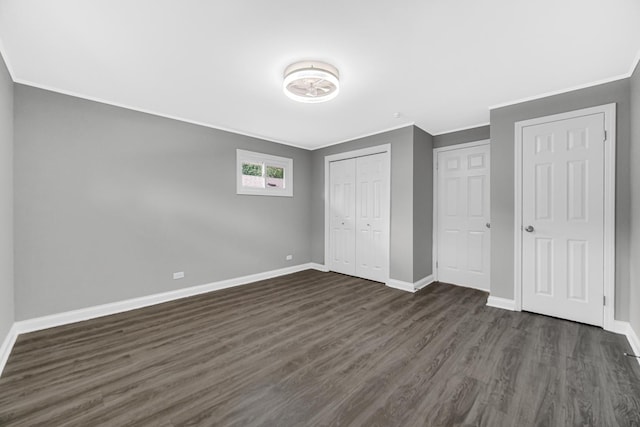3115 172nd St, Hazel Crest, IL 60429 - unfurnished bedroom with dark wood finished floors, ornamental molding, and a closet