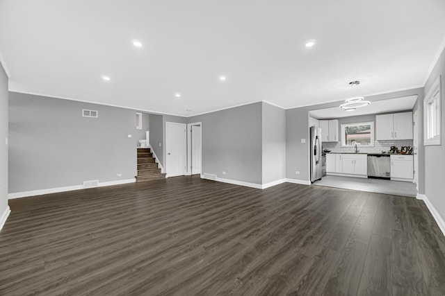 3115 172nd St, Hazel Crest, IL 60429 - unfurnished living room featuring ornamental molding, dark wood-type flooring, stairs, and recessed lighting