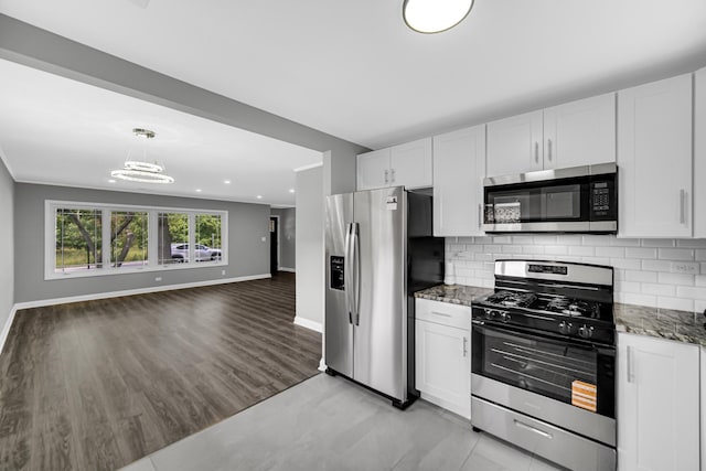 3115 172nd St, Hazel Crest, IL 60429 - kitchen with stainless steel appliances, dark stone counters, open floor plan, white cabinets, and recessed lighting