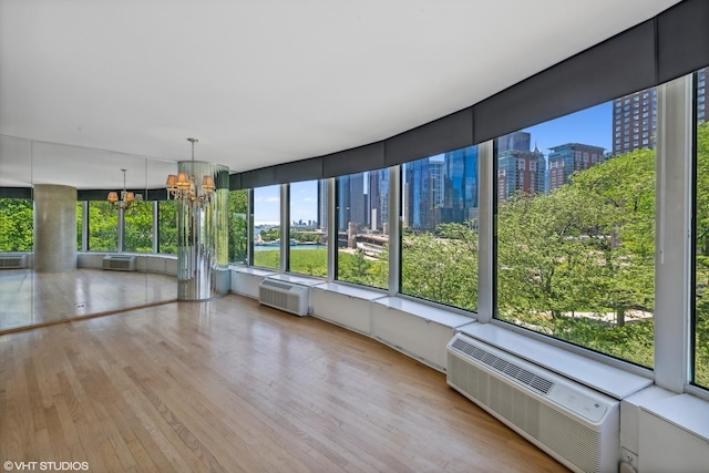 505 N Lake Shore Dr Unit 516, Chicago, IL 60611 - unfurnished sunroom with a chandelier, a city view, a wall mounted AC, and a wall mounted air conditioner