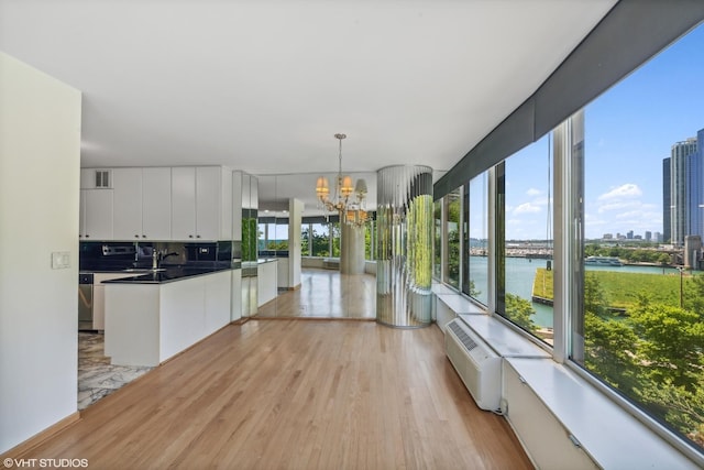 505 N Lake Shore Dr Unit 516, Chicago, IL 60611 - kitchen with a chandelier, white cabinetry, light wood-type flooring, dark countertops, and a water view