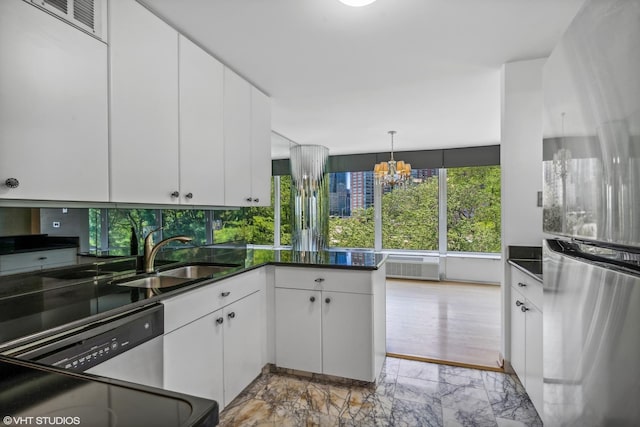 505 N Lake Shore Dr Unit 516, Chicago, IL 60611 - kitchen with plenty of natural light, dark countertops, appliances with stainless steel finishes, and white cabinetry